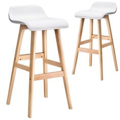 two wooden stools with white upholstered seat covers on each one and the other side