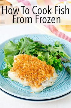 a blue plate topped with fish and greens