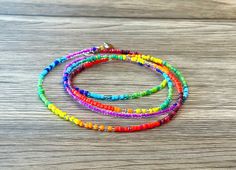 multicolored beaded bracelets on wooden table