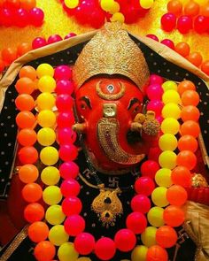 an idol is surrounded by balloons and streamers