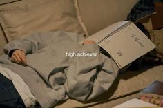 a person laying on a couch with a book in their hand and the words high achieve above them