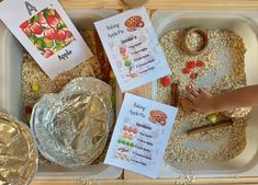 a plastic tray filled with food and cards for kids to write their name on it