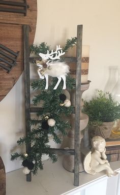 a christmas tree sitting on top of a wooden shelf