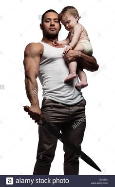 a man holding a baby in his arms