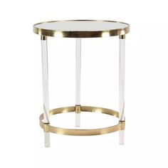 a round glass table with gold trimmings and a metal frame around the edge