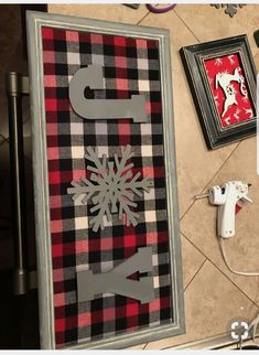 a christmas door decorated with plaid and snowflakes