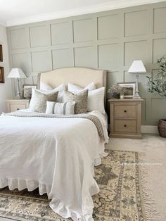 a white bed sitting in a bedroom on top of a wooden dresser next to a rug