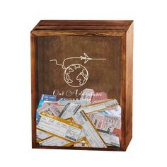 a wooden box filled with lots of different types of tickets and paper money in it