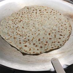 a tortilla is being cooked in a skillet