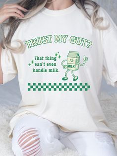 "Introducing our retro-inspired adult unisex comfort colors crewneck T-shirt, featuring a quirky graphic of a retro milk character and the humorous text, \"Trust my gut? That thing can't even handle milk.\" Crafted for comfort, this tee offers a relaxed fit and is made from high-quality materials. Embrace the playful charm of this design and showcase your sense of humor. Perfect for those who appreciate witty and lighthearted statements. Join the ranks of those who trust their instincts and wear it proudly. Let the world know that your gut has its limits, even when it comes to milk. Grab yours today and add a touch of retro humor to your wardrobe! Comfort Colors introduces its garment-dyed t-shirt; a fully customizable tee made 100% with ring-spun cotton. The soft-washed, garment-dyed fabr Milk Character, Milk Funny, My Tummy Hurts, Tummy Hurts, Lactose Intolerant, Funny Phrases, Retro Humor, Gen Z, Funny Shirt