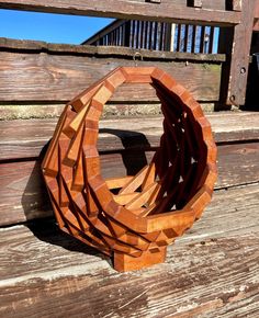 a wooden sculpture sitting on top of a wooden bench