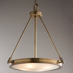 a light fixture hanging from the ceiling with two lights on each side and an oval glass shade