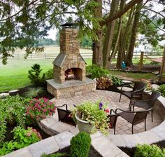 an outdoor fireplace in the middle of a garden