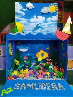 an ocean scene made out of cardboard with sea animals and fish on the bottom part