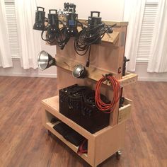 a wooden cart with several different types of electrical equipment in it