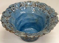 a blue bowl sitting on top of a white counter