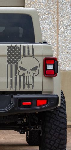 a truck with an american flag and skull decal on it