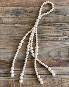 a white beaded necklace on a wooden surface