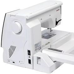 a white sewing machine sitting on top of a table