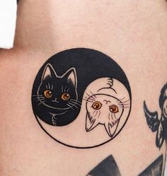 a woman's thigh with two cats on it