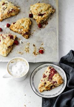 scones with cranberry filling on a plate next to a cup of coffee