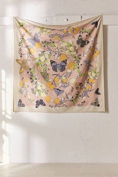 a wall hanging on the side of a building with a butterfly and lemon print fabric