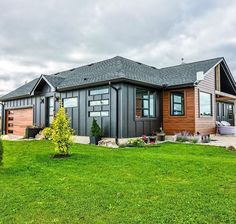 a large house sitting on top of a lush green field