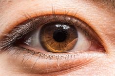 an extreme close up shot of someone's eye with the iris partially closed and visible