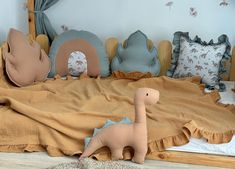 a bed with pillows and stuffed animals on top of it in a child's room