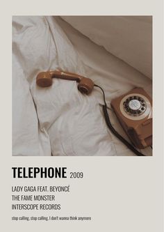 an old phone laying on top of a bed next to a white sheet and pillow