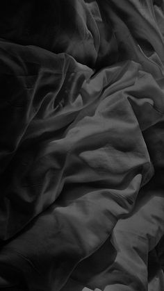 black and white photograph of an unmade bed