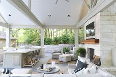 an outdoor living area with couches and tables