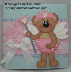 a card with a teddy bear holding a pink heart and angel wings on it's chest