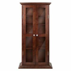 a tall wooden cabinet with glass doors on the front and bottom shelves in dark wood