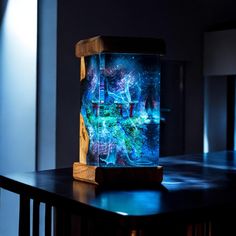 a wooden table topped with a glass vase filled with water and stars in the sky