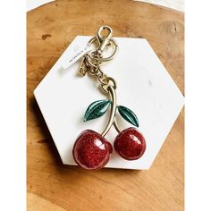 two cherries are attached to a key chain