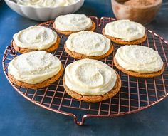 cookies with white frosting sitting on a cooling rack