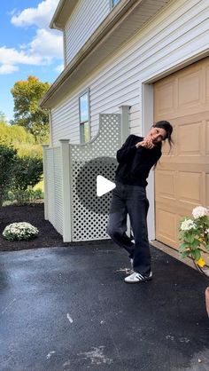 a man standing in front of a garage