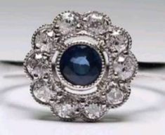 This lovely antique beauty consists of one central blue sapphire, set in a bezel setting. Approximate sapphire weight is. 66ctw. Surrounding the sapphire are beautiful bright, white diamonds. G-H color. VS clarity. Approximate carat weight is .80ctw. Set in platinum. A sizable 6.25. I feel it would make a lovely engagement ring. Simple, elegant, classic. Exquisite Sapphire Ring, Antique Silver Sapphire Diamond Ring, Antique Sapphire Jewelry With Center Stone, Antique Silver Diamond Ring With Sapphire, Antique Sapphire Diamond Ring In Silver, Vintage Sapphire Ring With Halo Setting, Antique Blue Sapphire Diamond Ring, Vintage Blue Sapphire Ring With Bezel Setting, Vintage Sapphire Ring With Bezel Setting For Wedding