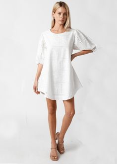 Whatever the occasion the Kelly White Eyelet Puff Sleeve Shift Dress is ready to go! White eyelet lace fabric forms a puff sleeve babydoll dress with a rounded neckline, shift bodice, rounded hem, and keyhole cutout back. Features ties at the sleeves. Lined. DETAILS & FIT Loose Fit. 100% Cotton. Machine wash cold. Imported. SHIPPING & RETURNS Orders are processed within 1-2 business days. Packages are shipped out Monday-Friday, holidays are excluded. Priority, Priority Mail Express, and all expe Spring Eyelet Puff Sleeve Dresses, Spring Eyelet Dress With Puff Sleeves, Eyelet Short Sleeve Dresses For Brunch, Short Sleeve Eyelet Dress For Brunch, White Eyelet Dress For Brunch, Puff Sleeve Broderie Anglaise Dress For Daywear, White Balloon Sleeve Dress For Daywear, White Puff Sleeve Mini Dress With Lace Trim, Short Sleeve Mini Dress With Lace Sleeves For Brunch