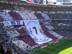 a soccer stadium filled with lots of people and banners hanging from the sidelines in front of them