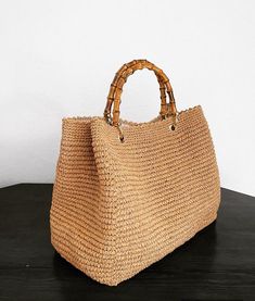 100% handmade straw large bag with bamboo handles .  Please do not hesitate to contact me for other colour options . Due to the handmade nature of the bags, interior lining may change according to stock and there may be slight variations in size. Top Handle Jute Bag With Bamboo Handle, Jute Top Handle Bag With Bamboo Handle, Jute Bag With Bamboo Handle And Top Handle, Eco-friendly Top Handle Shoulder Bag With Bamboo Handle, Eco-friendly Rattan Bags With Braided Handles, Straw Handbags, Top Handle Handbags, Bamboo Handles, Top Handle Bags