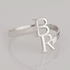 Personalized Initials Ring - These types of rings are often customized to include the initials of a couple's first names, the initials of family members, or any two meaningful letters that hold significance to the wearer. Materials  * High Quality 925 Sterling Silver * Gold Plating options: 24K Gold Plating  * Handmade item SIZES * Initial size: 18mm * Ring length: 2.5mm * Ring Thickness:1.2mm * Ring size: US Sizes 3-13 (Intervals of half) GIFTING All items come ready to give in a beautiful gift White Initial Ring For Anniversary, Personalized White Sterling Silver Ring, White Sterling Silver Ring For Personalized Gift, Adjustable Silver Initial Ring For Personalized Gift, Personalized Silver Initial Ring With Custom Name, White Initial Ring For Promise, White Initial Ring For Promise Occasion, Personalized Initial Ring In White Gold, Personalized Initials White Gold Rings