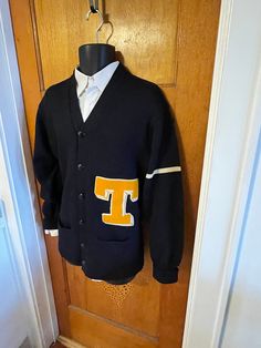 Vintage 50s wool letterman sweater  Dark blue knit  v neck with button front  2 hip pockets Gold letter T with white trim and a white stripe on the left arm label reads: "Whiting Los Angeles" good condition with no notable flaws Sweater measures as a mens size medium but please check measurements: 40"-41" chest 42" bottom width 30"  length 33 1/4"  sleeve from center back of neck with cuff down 20.5" shoulder to shoulder Annie SAYS Check out my other listing for more great things! Usps priority domestic shipping  Please read all my store policies and email me with any questions. Thanks for shopping at antique!  Always from a smoke-free, good energy environment! Varsity Cardigan For Winter College Season, Varsity Style Winter Cardigan For College, Varsity Style Cardigan For College In Winter, Winter Varsity Cardigan, Varsity Cardigan With Ribbed Cuffs, Collegiate Long Sleeve Cardigan For College, Collegiate Cardigan For College In Fall, Collegiate Fall Cardigan For College, Collegiate Style Cardigan For Fall College Season