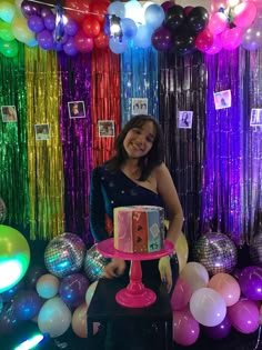 a woman standing in front of a birthday cake