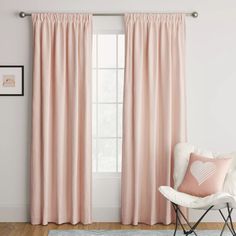 the pink curtains in this room are ready to be hung