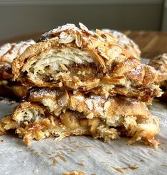 a stack of pastries sitting on top of a table covered in powdered sugar