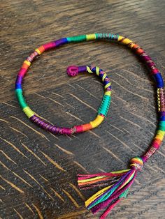 a multicolored beaded necklace on a wooden table