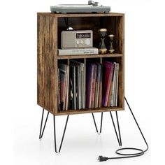 an old record player is sitting on top of a shelf with some books and records