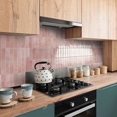 a stove top oven sitting inside of a kitchen next to wooden counter tops and cabinets